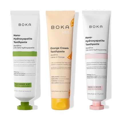 Three n-Ha Toothpaste 3-Pack tubes in tasty flavors stand upright on display for oral care.
