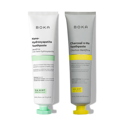 Two n-Ha Toothpaste 2-Pack tubes stand upright, formulated to remineralize teeth and strengthen enamel.