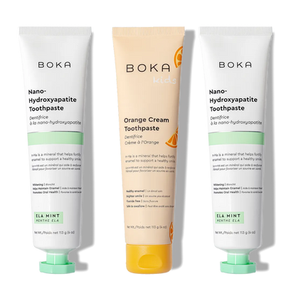 N-Ha Toothpaste 3-Pack: two Ela Mint and one Orange Cream Kids tubes standing upright.
