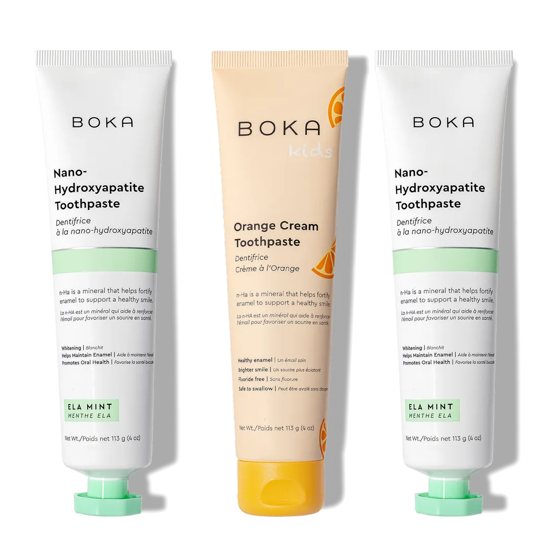N-Ha Toothpaste 3-Pack: two Ela Mint and one Orange Cream Kids tubes standing upright.