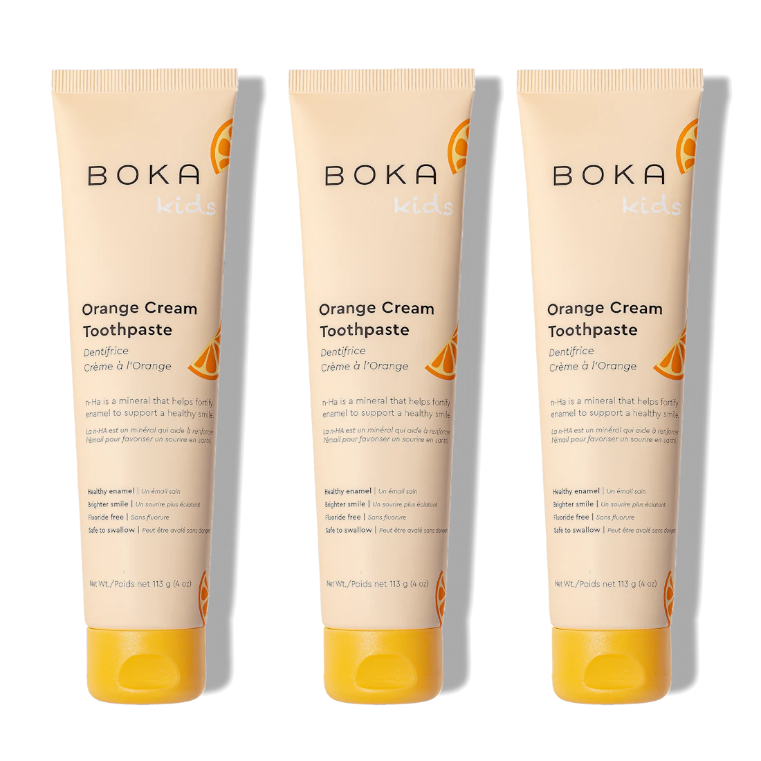 Three n-Ha Toothpaste 3-Packs for kids in Orange Cream are placed side by side on a white background.