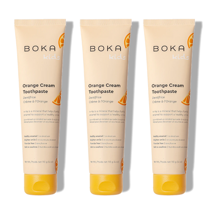 Three n-Ha Toothpaste 3-Packs for kids in Orange Cream are placed side by side on a white background.