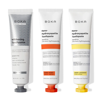 Three Nano n-Ha Toothpaste Whitening 3 Packs—Whitening, Cinna Mint, Lemon Lavender—stand upright.