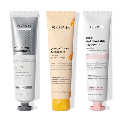Three upright Boka Nano (n-Ha) Whitening 3 Pack toothpastes: Whitening and Orange Cream.